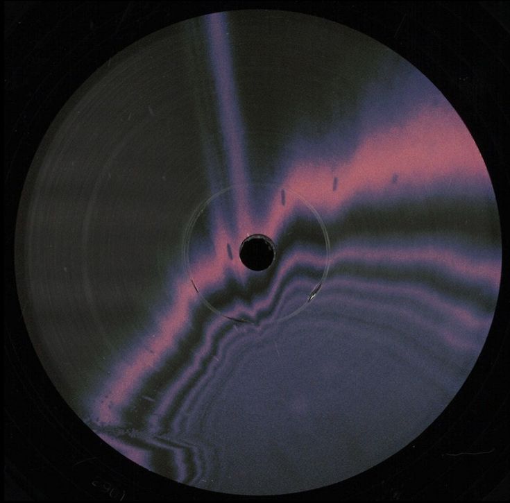 a black disc with pink and blue swirls on the disk cover is in front of a black background