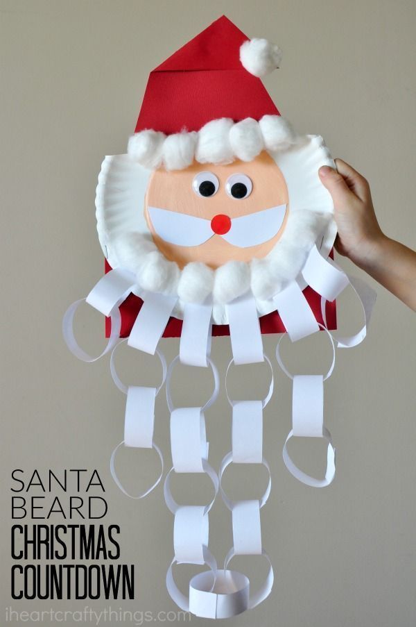 santa beard paper plate christmas decoration hanging from the ceiling with ribbon and glue on it