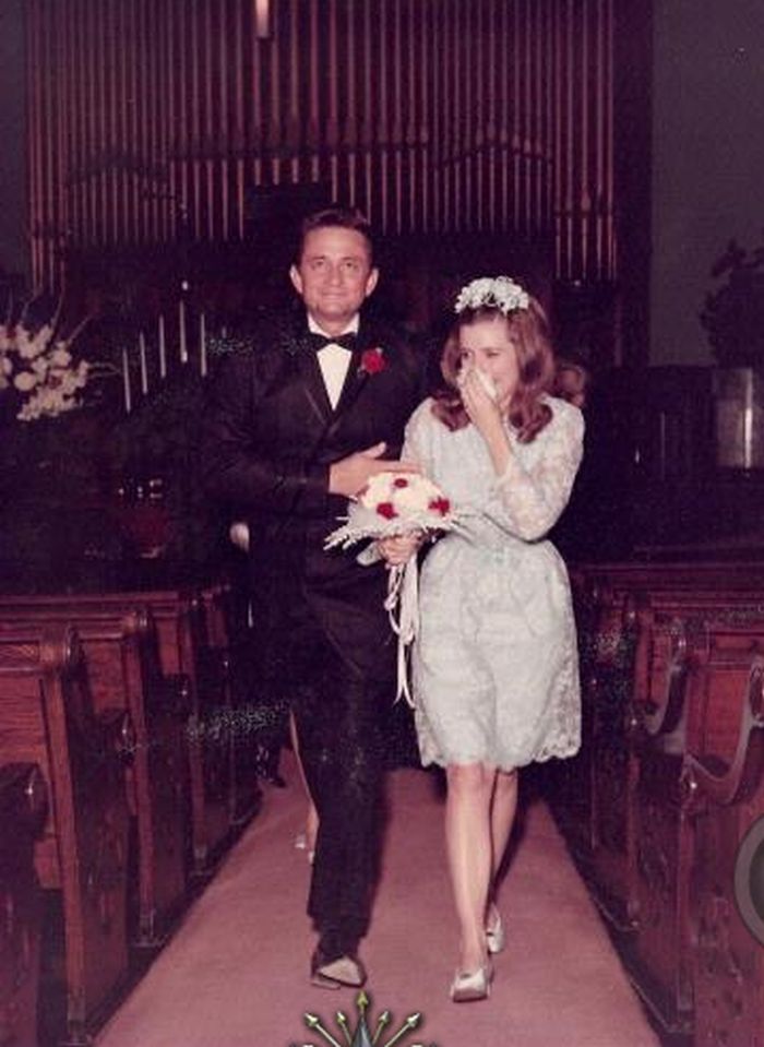 an old photo of a man and woman walking down the aisle