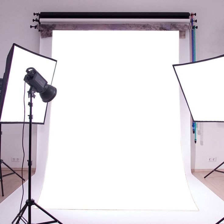 three photography lighting equipment set up in front of a white backdrop for a photo shoot