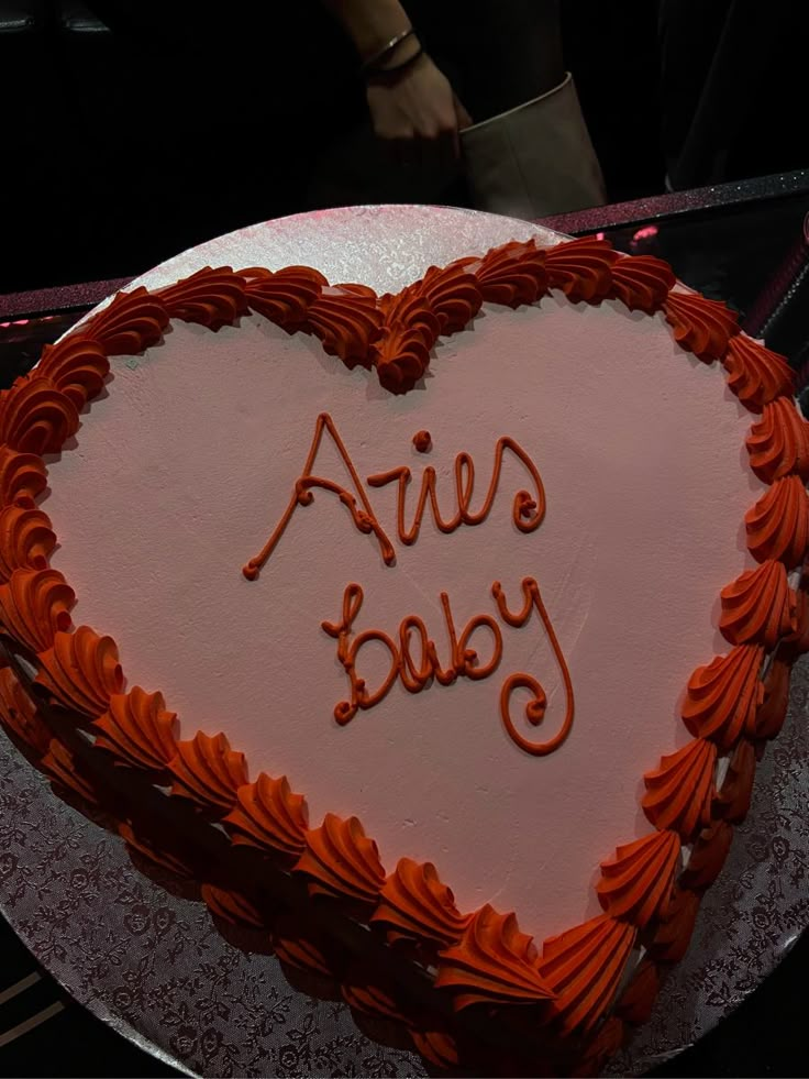 a heart - shaped cake with the words alive on it is being served to someone