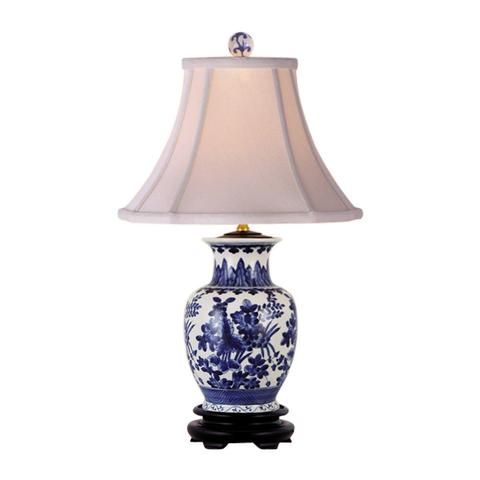 a blue and white lamp with a shade on it