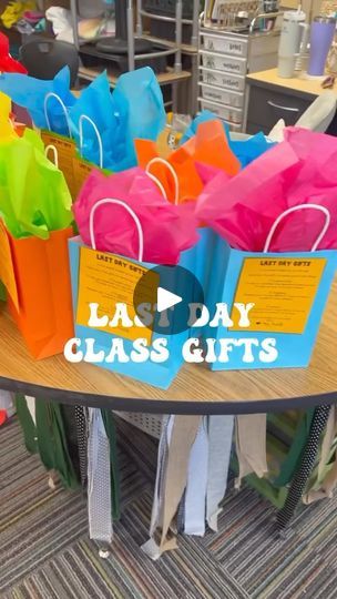 colorful shopping bags with the words la day class gifts sitting on top of a table