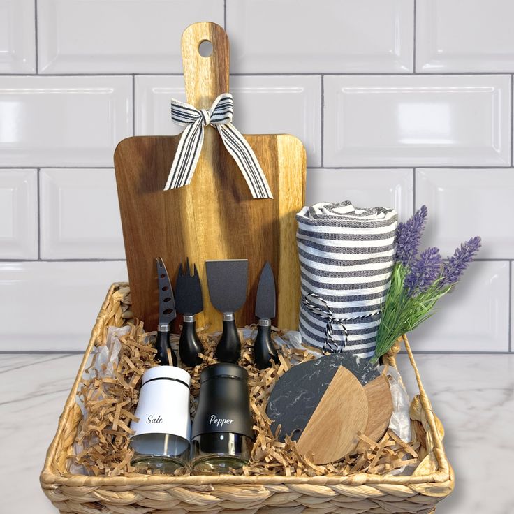 a basket filled with kitchen utensils on top of a white tile countertop