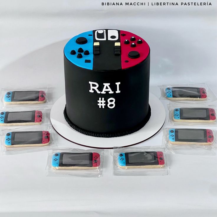 a black cake with red and blue controllers on it