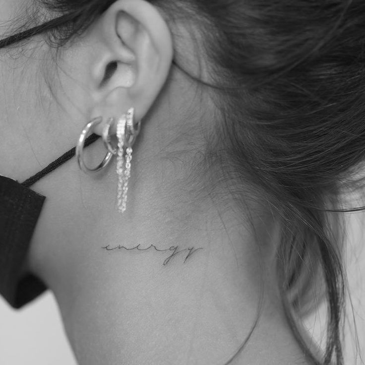 a woman's neck with the word may tattooed on her left side ribcage