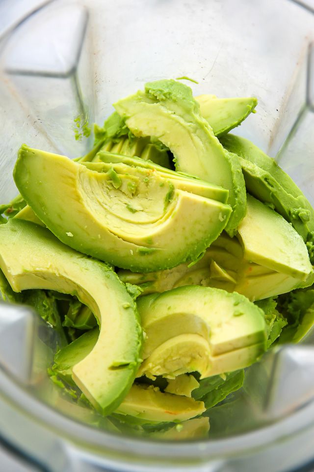 an avocado is cut into pieces in a blender