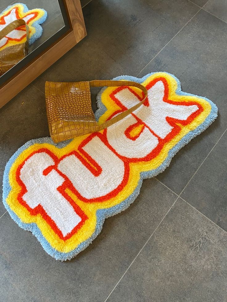 a rug that says laugh on the floor next to a mirror