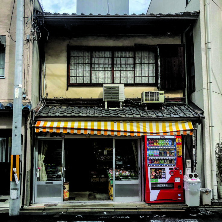 an old building with a store front and awnings on the side of it