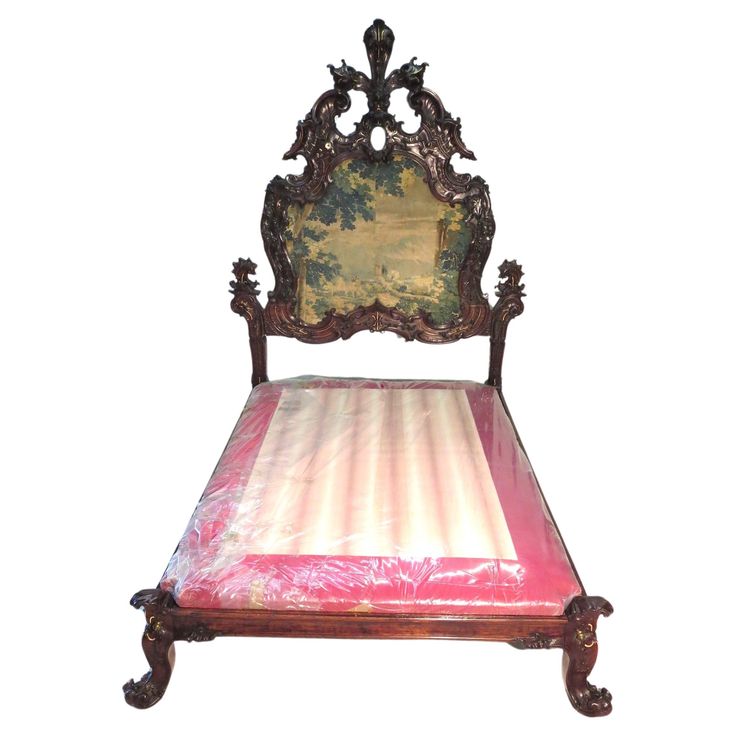 an old fashioned bed with pink sheets and wooden headboard on white background for display