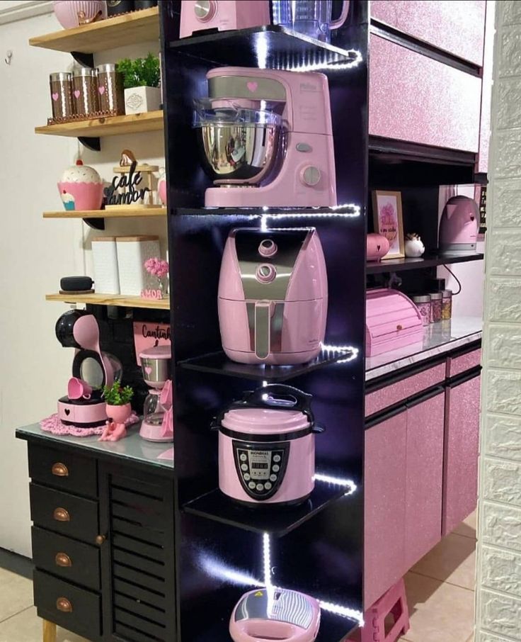 a kitchen with pink appliances on display in the center and shelves filled with other items