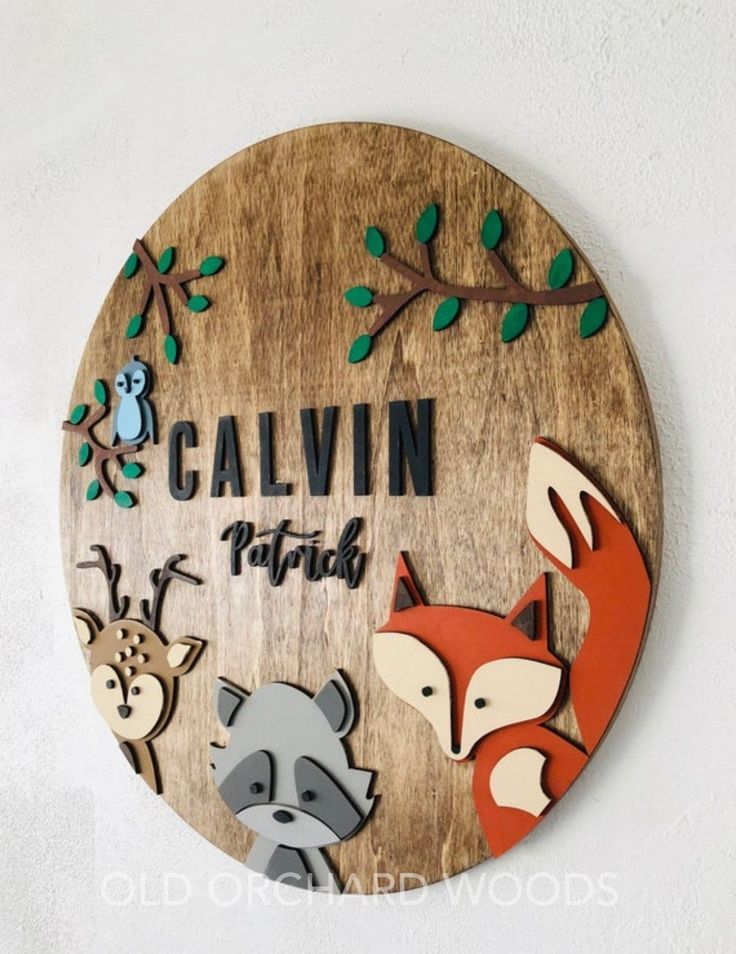 a wooden sign that says cavin with animals on it