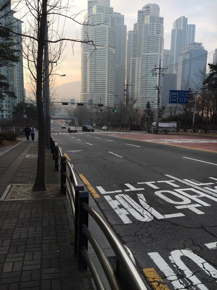 an empty city street with buildings in the background