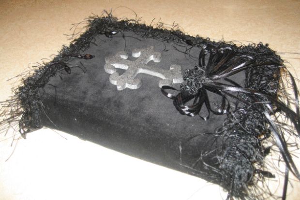 a black bag with a skull and crossbones on the front is sitting on a table