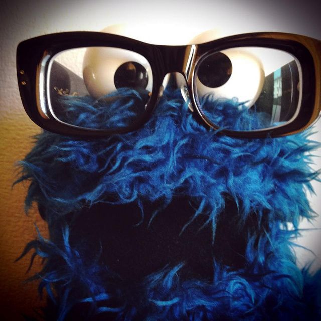 a close up of a cookie monster wearing glasses