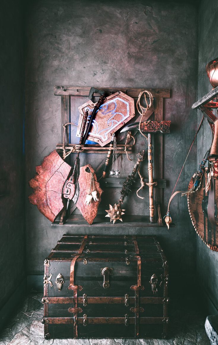 an old trunk is sitting in the corner of a room with other items on it