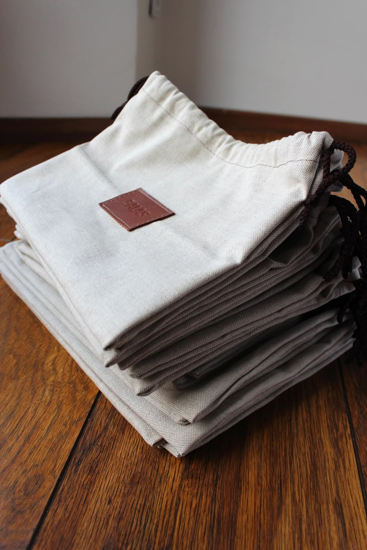 a stack of folded linens sitting on top of a wooden floor