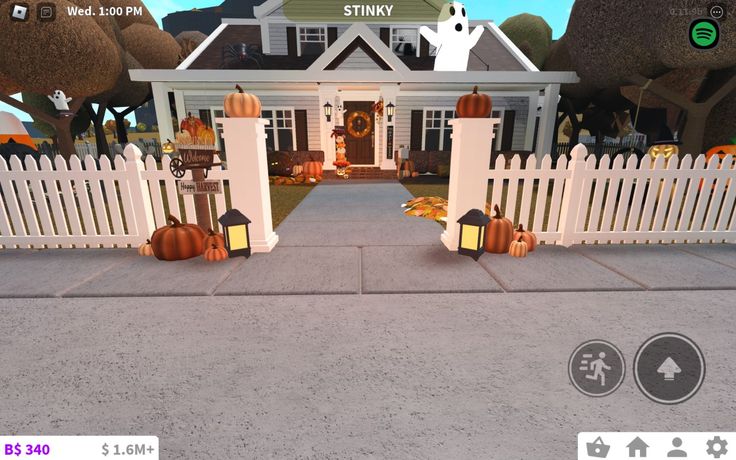 a virtual view of a house with pumpkins on the front yard and halloween decorations around it