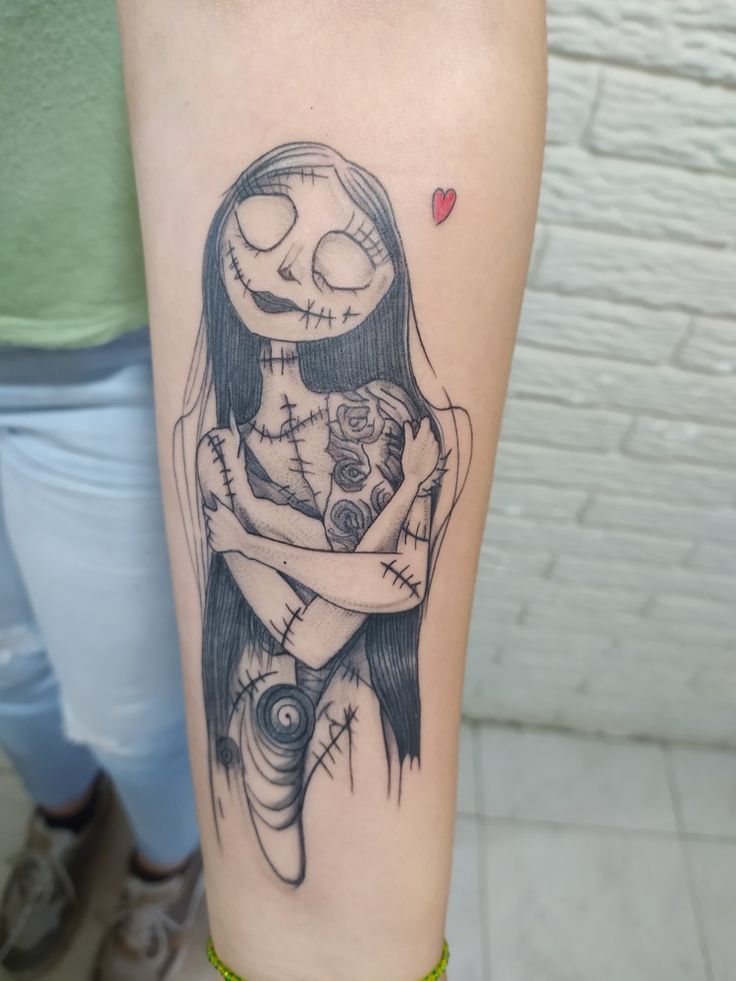 a woman with a skeleton tattoo on her arm holding a teddy bear in her arms