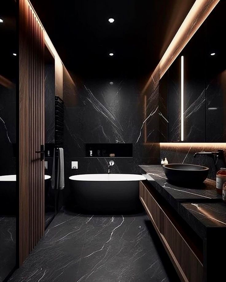 a bathroom with a tub, sink and large mirror in it's dark color scheme