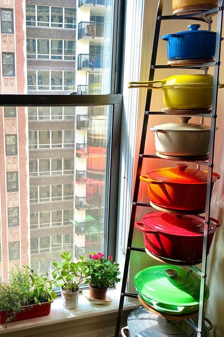 a window sill filled with pots and pans in front of a large window