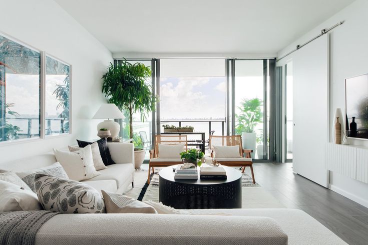 a living room filled with furniture and lots of windows