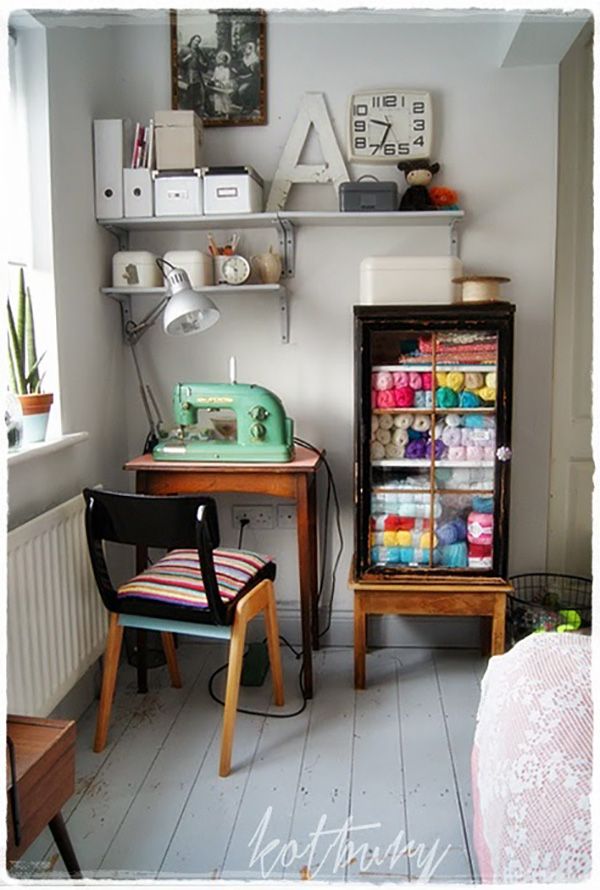 a sewing machine sitting on top of a wooden table next to a desk and chair