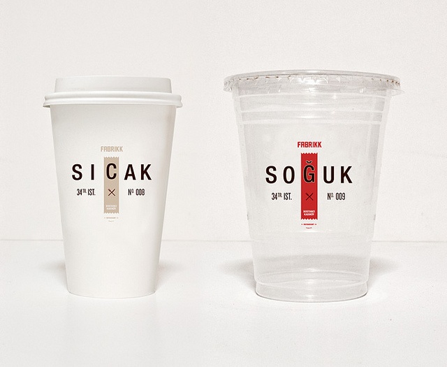 two plastic cups sitting next to each other on a white counter top, one with the word soukk printed on it