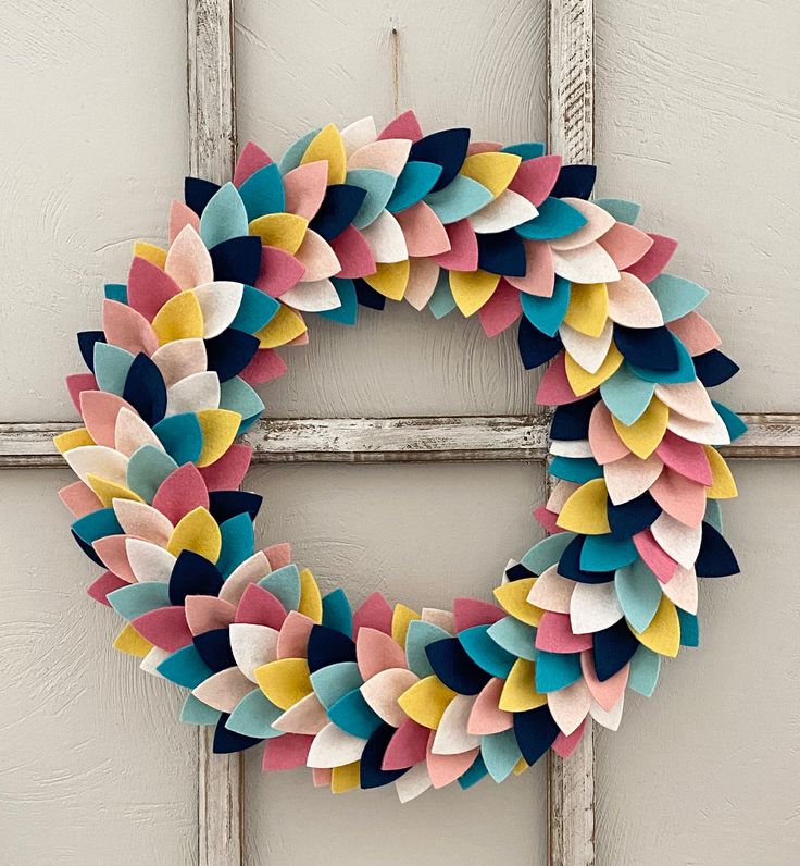 a colorful wreath hanging on the side of a door