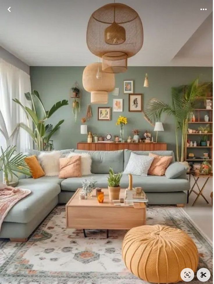 a living room filled with furniture and lots of plants on the wall above it's coffee table