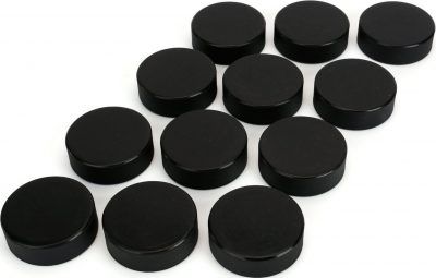 many black plastic caps are arranged on a white surface