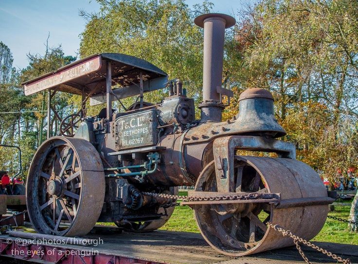 an old steam engine sitting on top of a train track