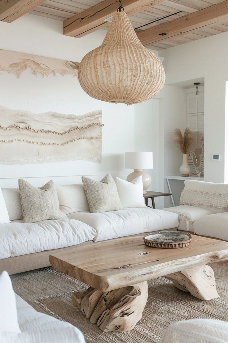 a living room with white furniture and wood accents