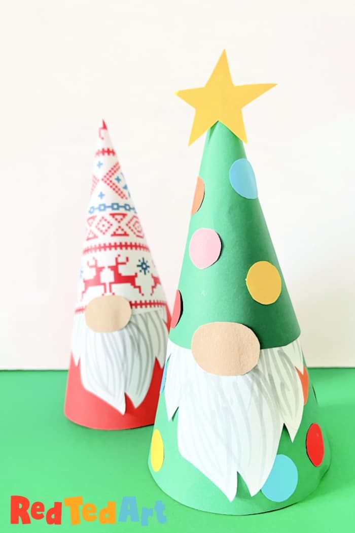 two paper hats with different designs on them, one is green and the other is red