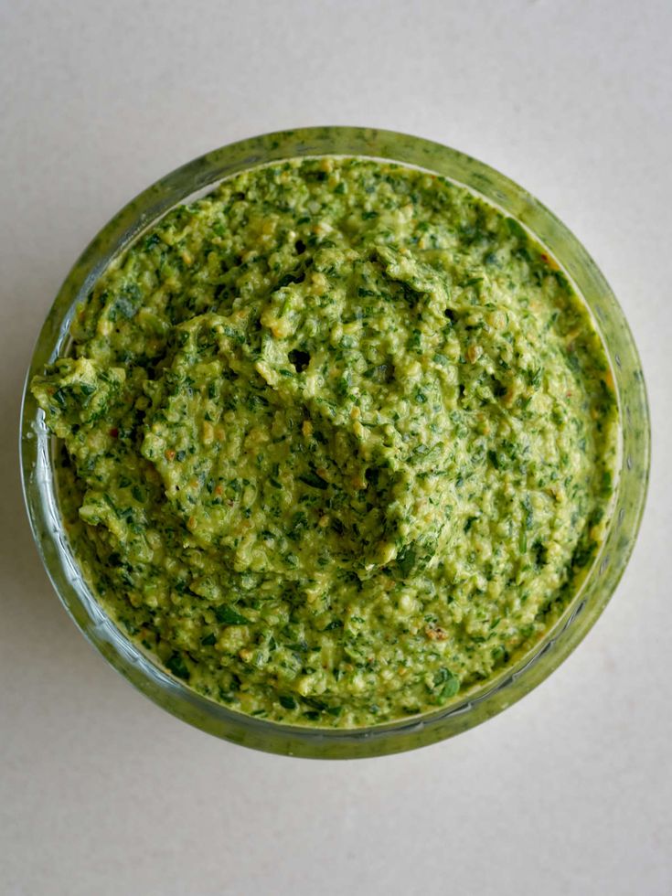 a small glass bowl filled with green pesto