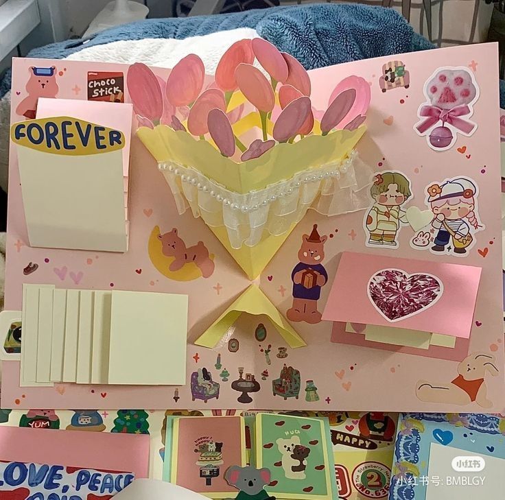 an assortment of items are displayed on a pink card board with lots of stickers