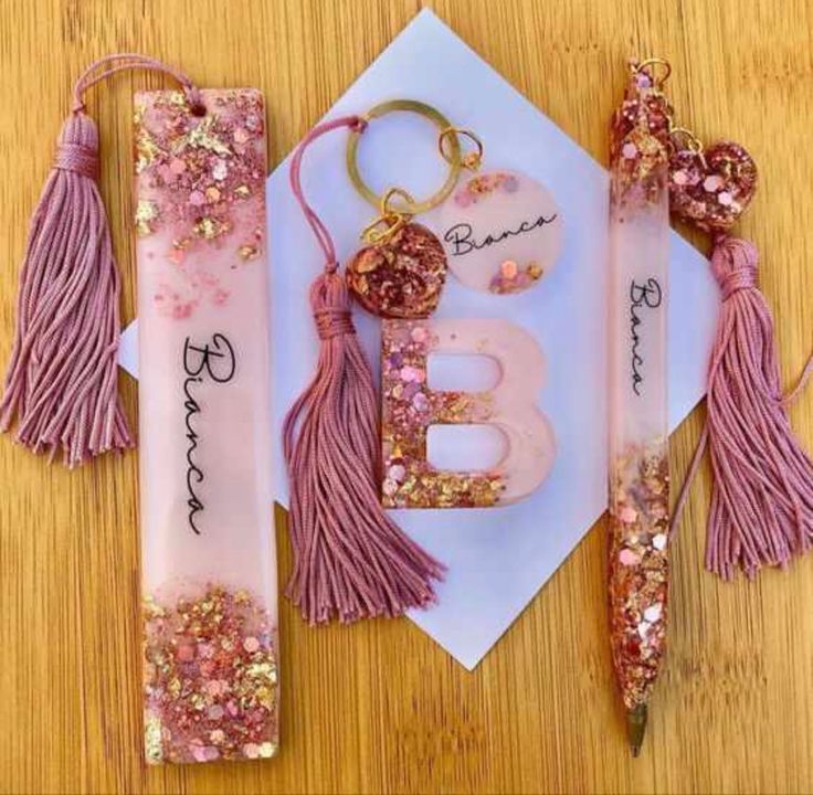 pink and gold birthday card with tassels, keychain, and bottle opener