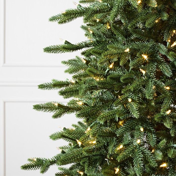 a green christmas tree with lights on it