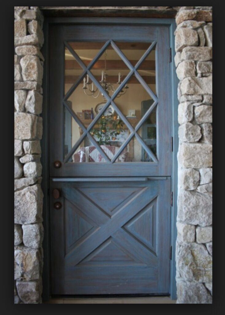 the front door is made out of wood and stone