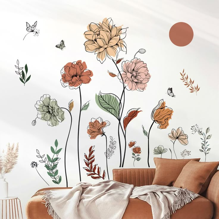 a living room with flowers painted on the wall and a couch in front of it