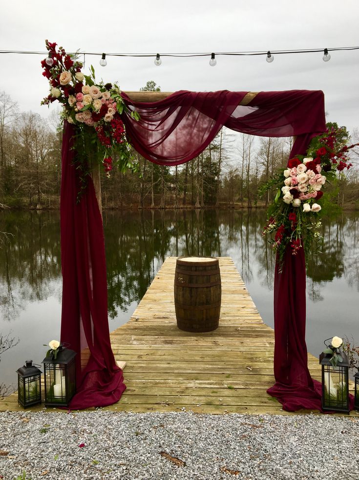 a wooden dock with flowers and candles on it