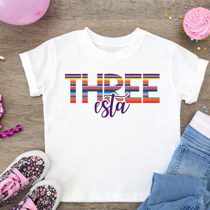 a t - shirt with the word tribe esta on it next to shoes and confetti