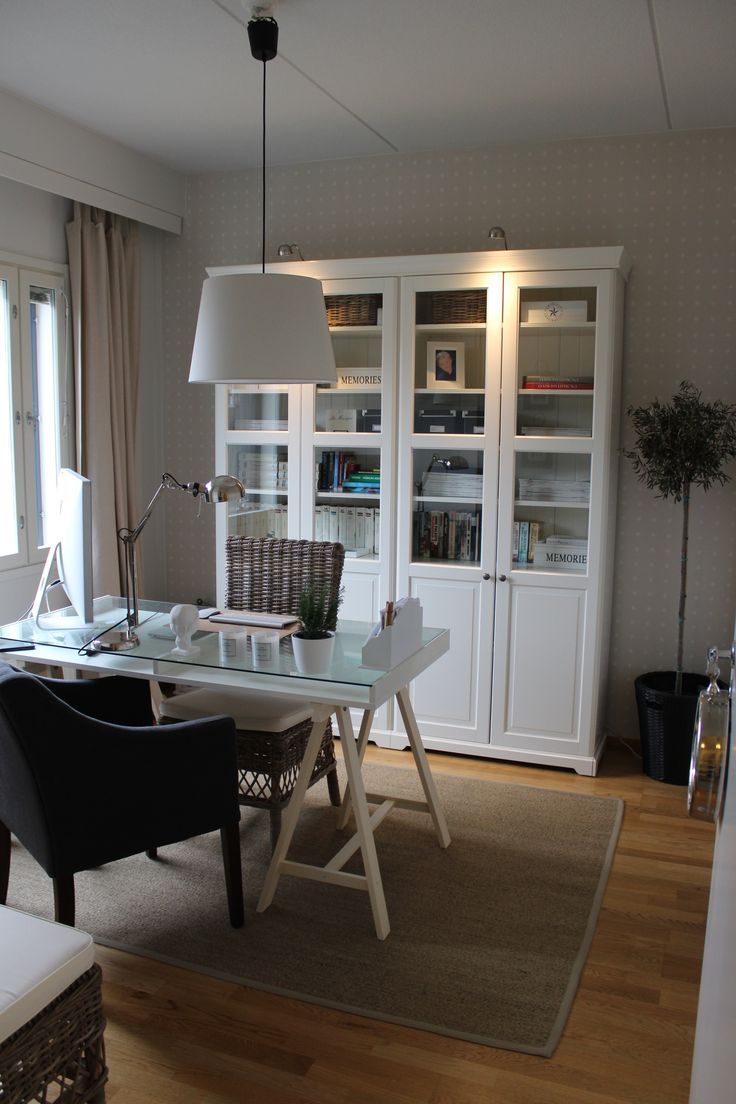 a room with a desk, chair and bookshelf