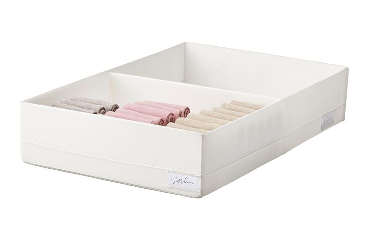 an open drawer with towels in it on a white surface, showing the bottom section