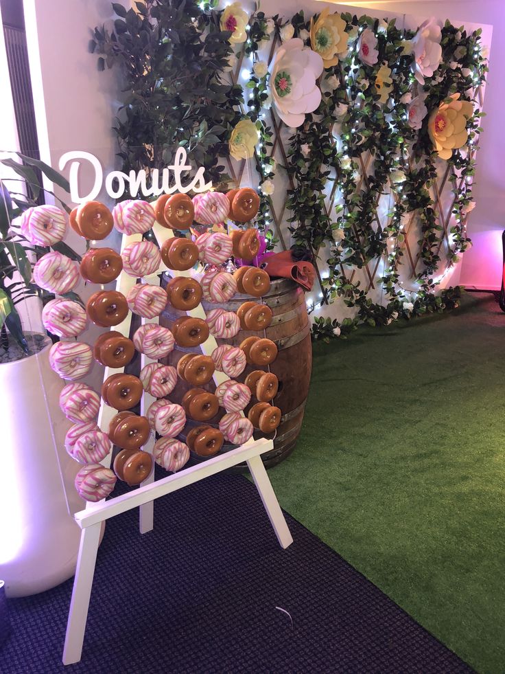 there are many donuts on display in front of a sign that says donuts