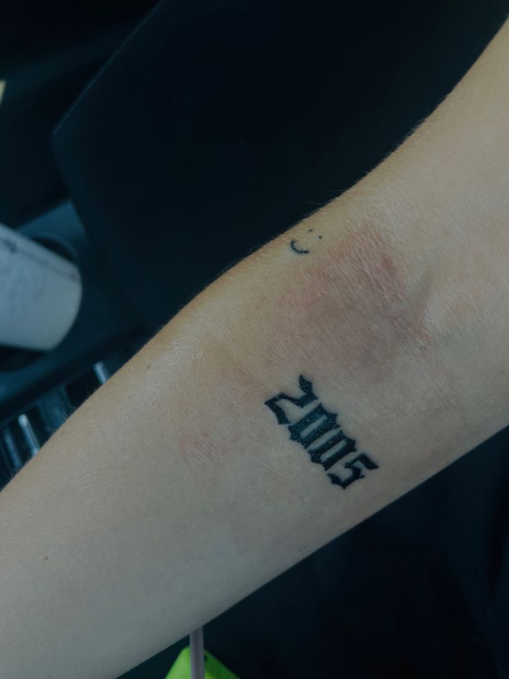 a person with a tattoo on their arm that says,'faith'in black ink