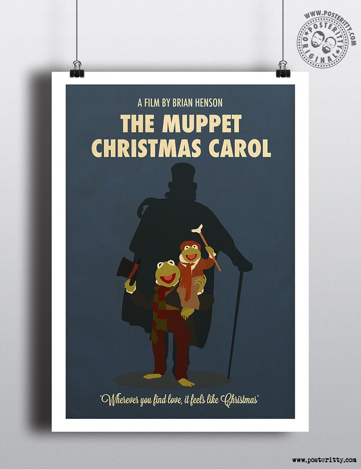 the muppet christmas carol poster is hanging on a wall next to a white clock