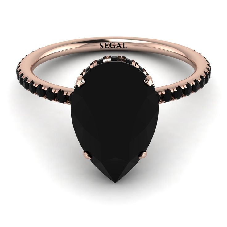 a rose gold ring with black stones and the word seal on it's side