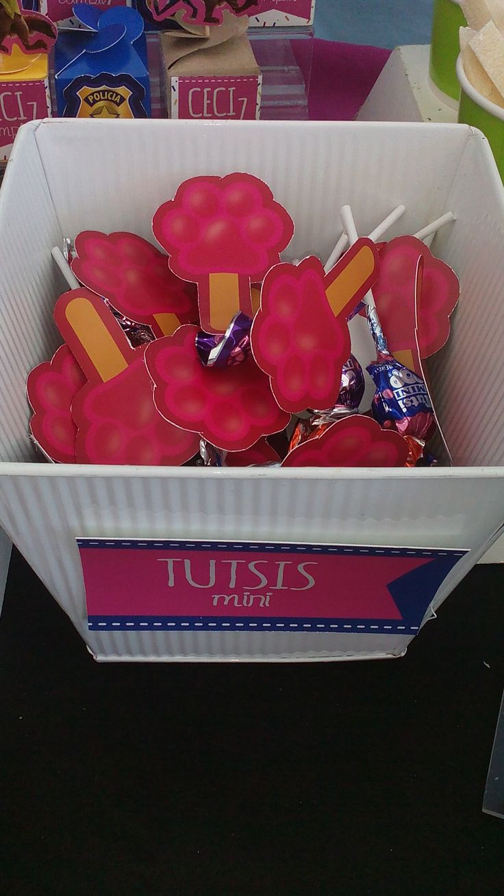 a box filled with lots of pink lollipops