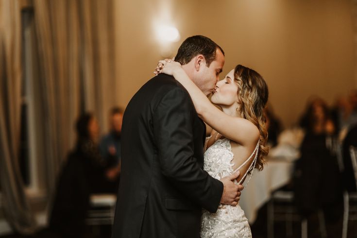 a bride and groom share their first dance